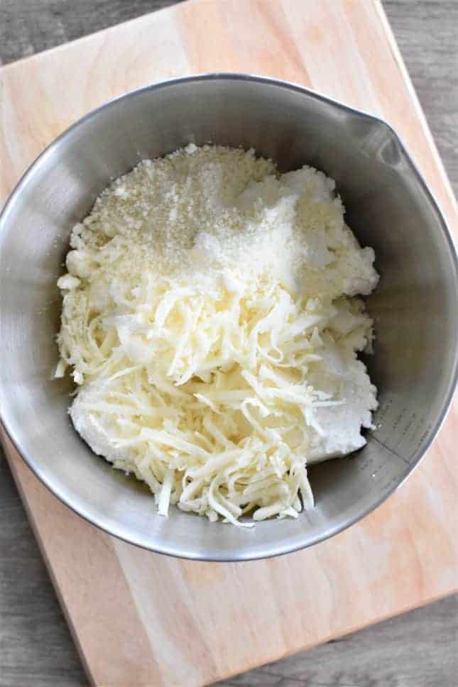 Ricotta, mozzarella and pecorino romano cheese in a mixing bowl