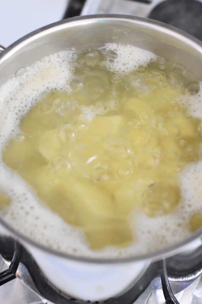 Potatoes boiling in a pot of water