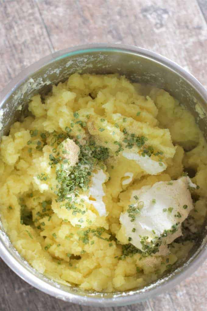 Mashed Potatoes in a pot with seasonings and sour cream