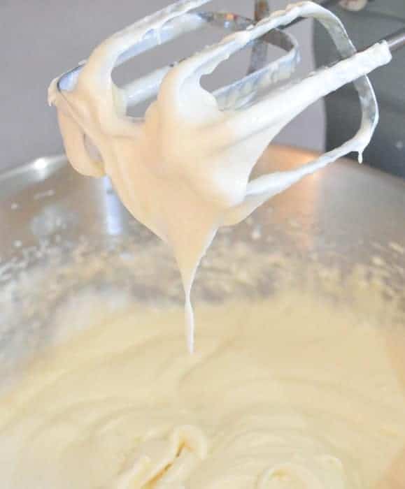 mixing the cake batter in a mixing bowl with an electric mixer 