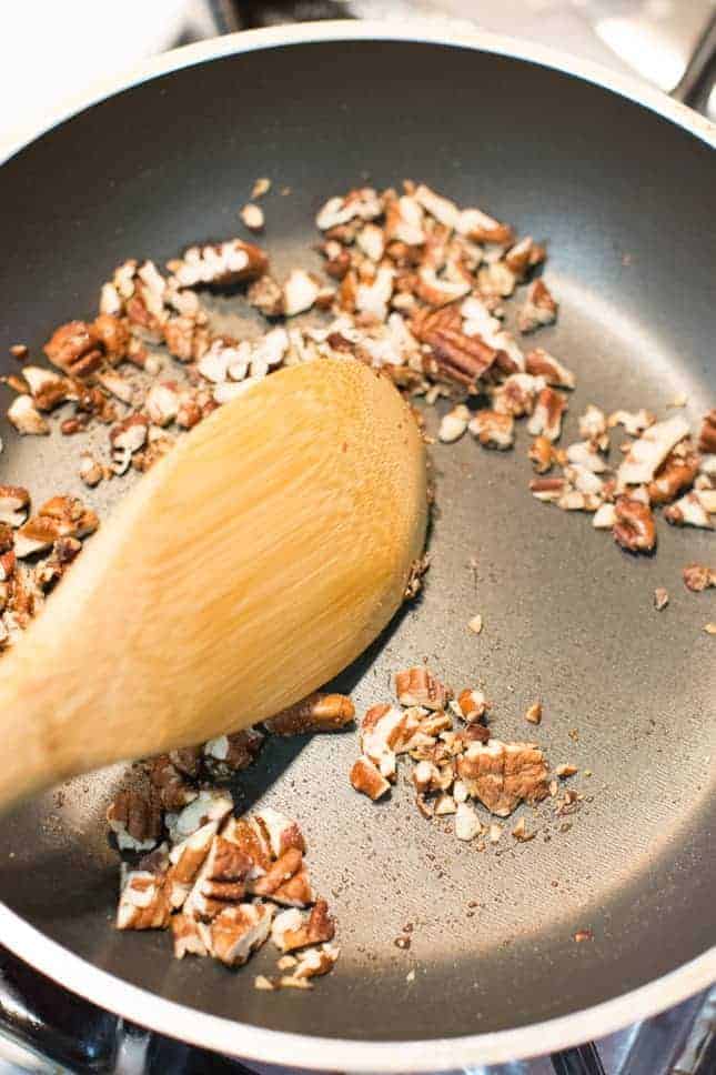 Toasting chopped pecans with cinnamon-sugar