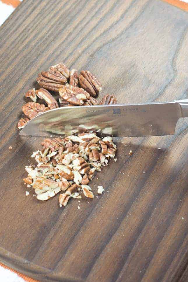 Chopping pecans on cutting board