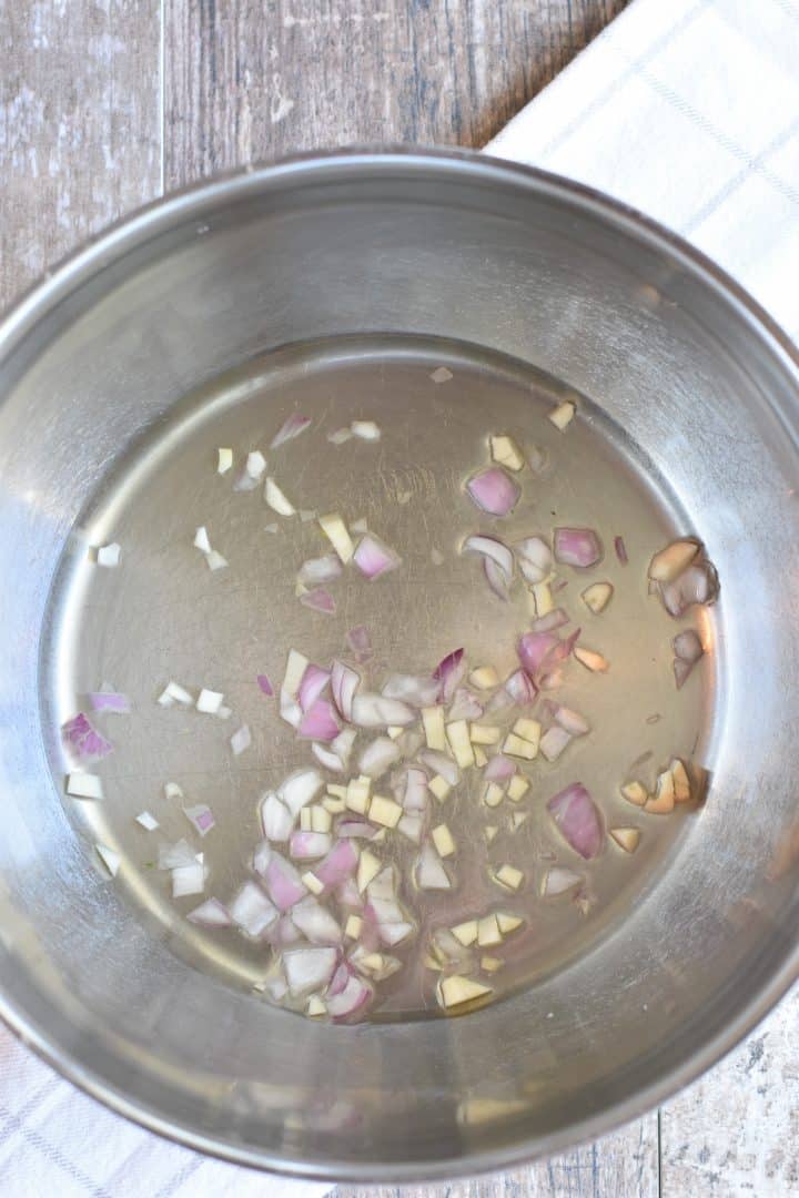 Wine, shallot and garlic in soup pot