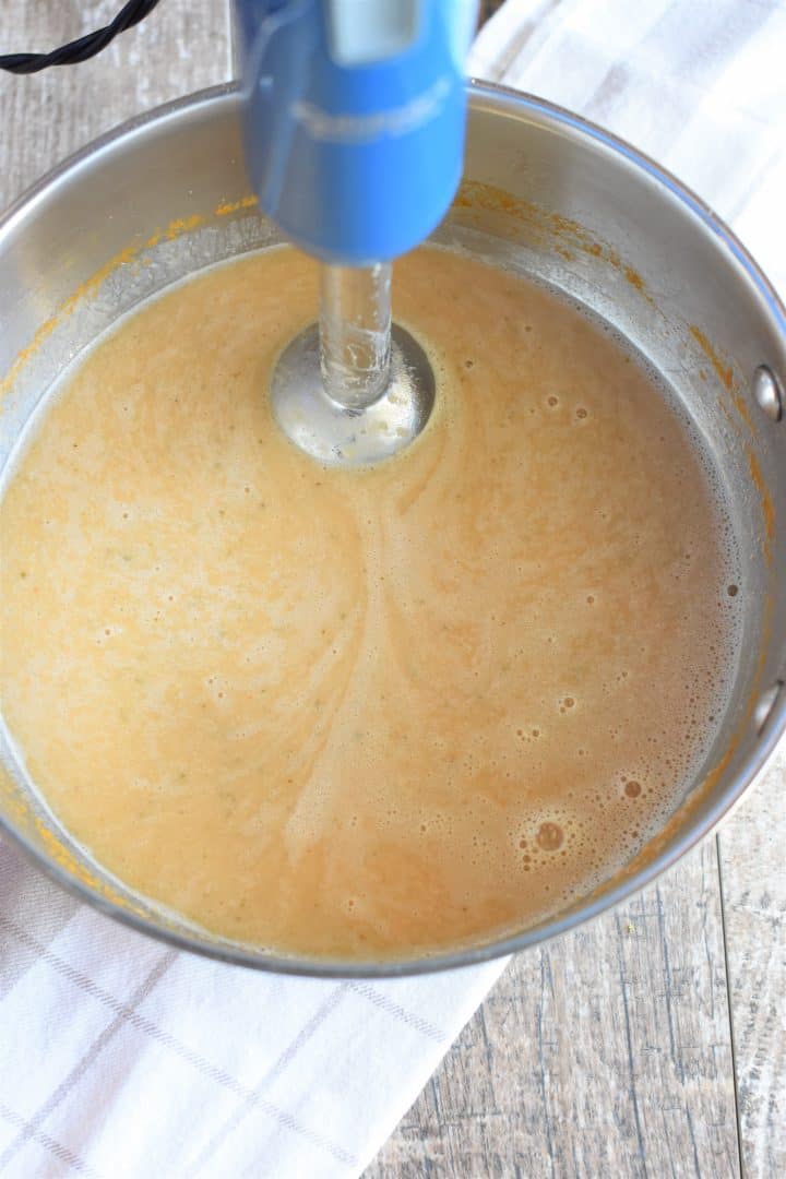 Using immersion blender to puree the soup