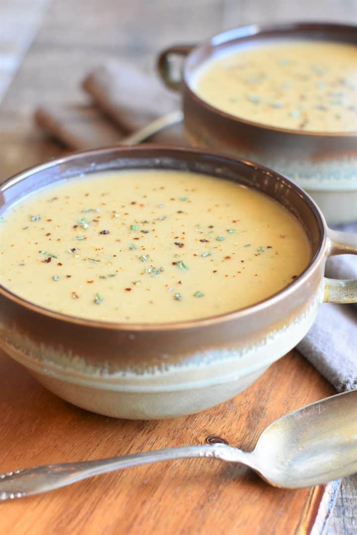 vegan white bean soup in two rustic bowls