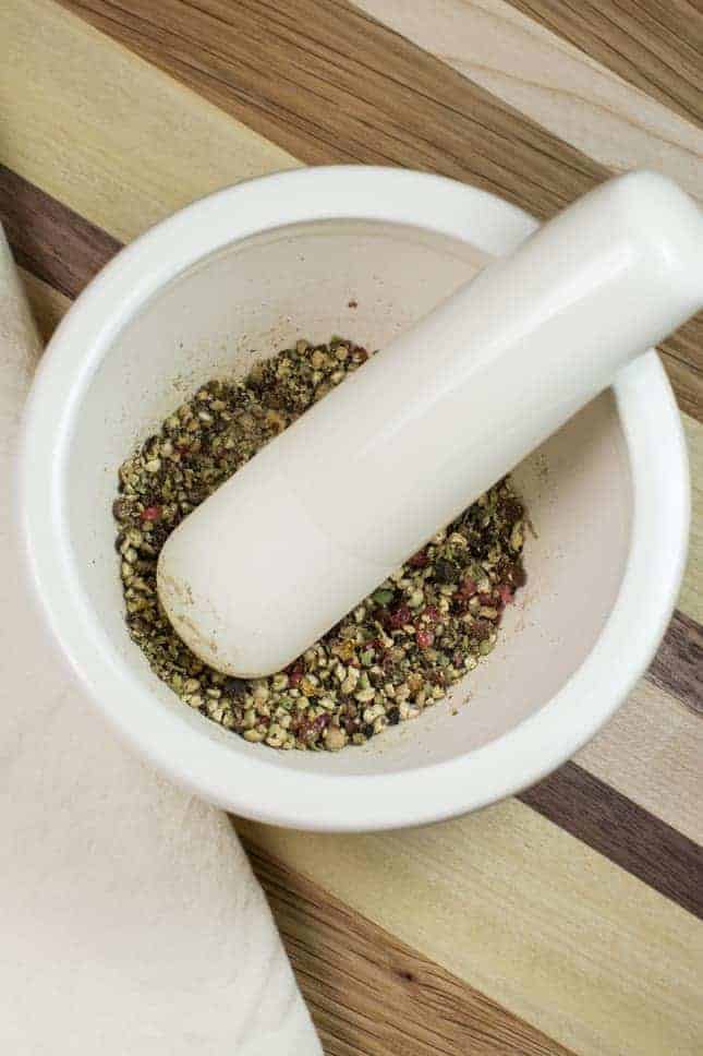 grinding peppercorns with mortar and pestle