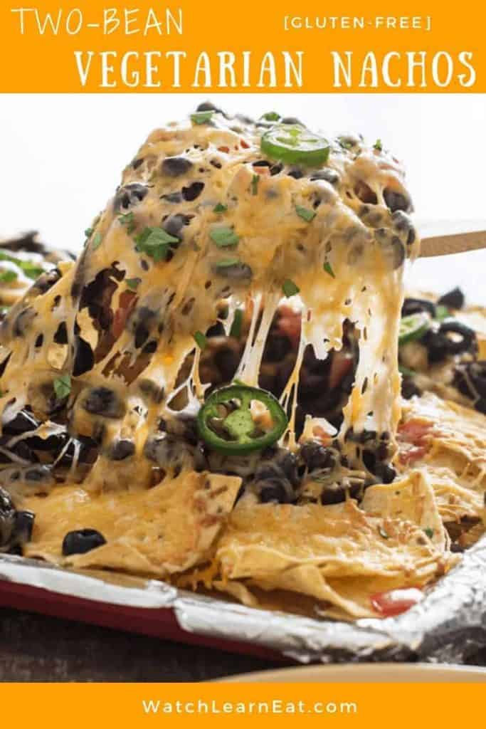 pin showing pulling up the cheesy nachos from the baking sheet