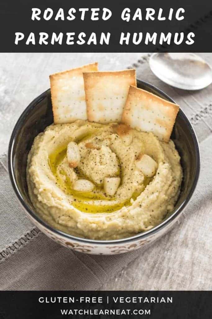 pin showing hummus in a bowl garnished with garlic, olive oil and black pepper and crackers in it