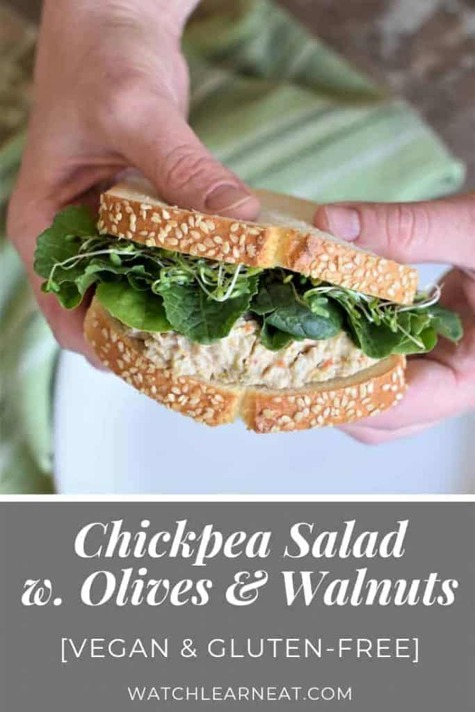 pin showing hands holding a chickpea salad sandwich