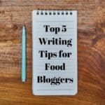notepad with text saying top 5 writing tips for food bloggers and pen next to it