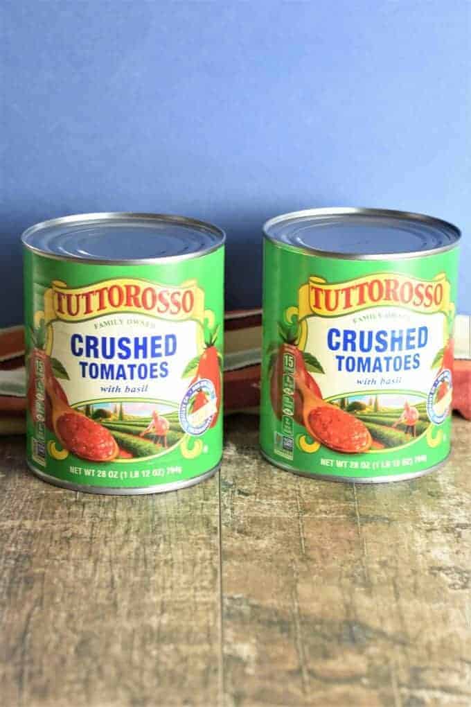 Two cans of Tuttorosso crushed tomatoes