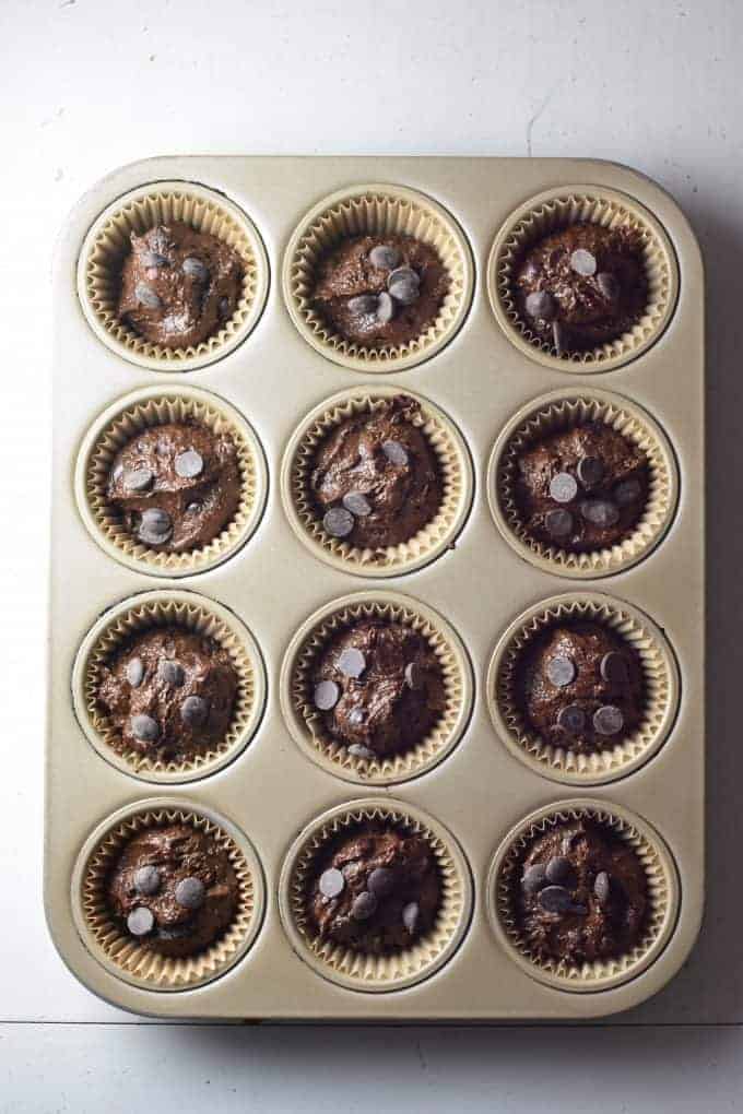 Muffin mix in baking cups in muffin pan