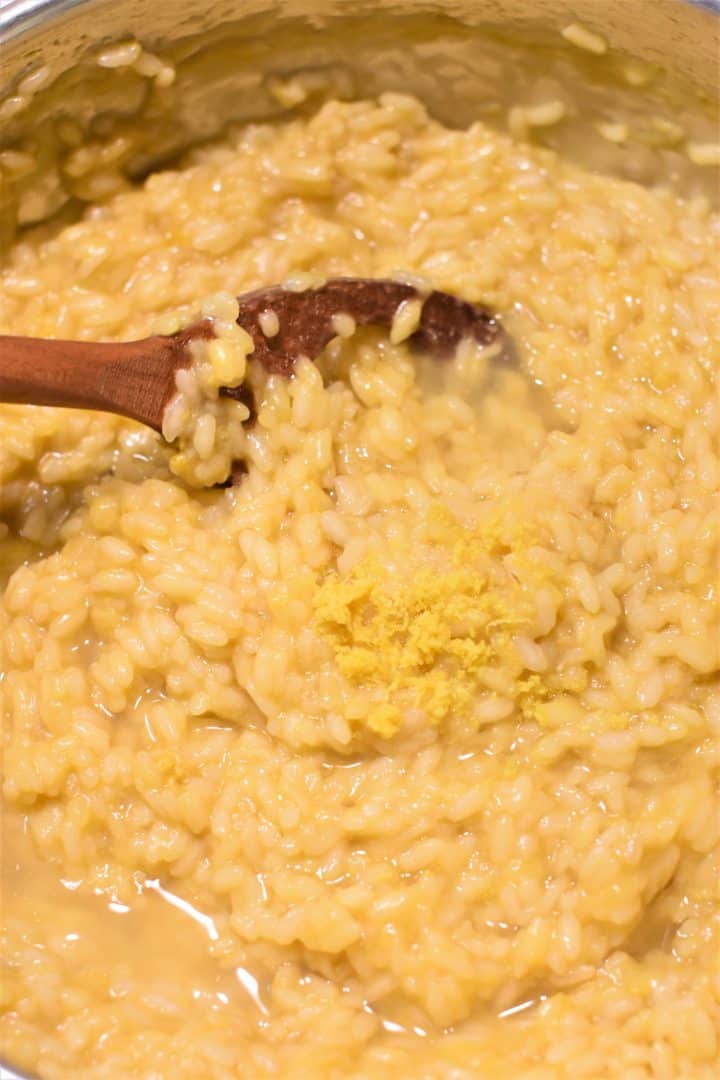 Lemon zest and juice added to risotto in pan