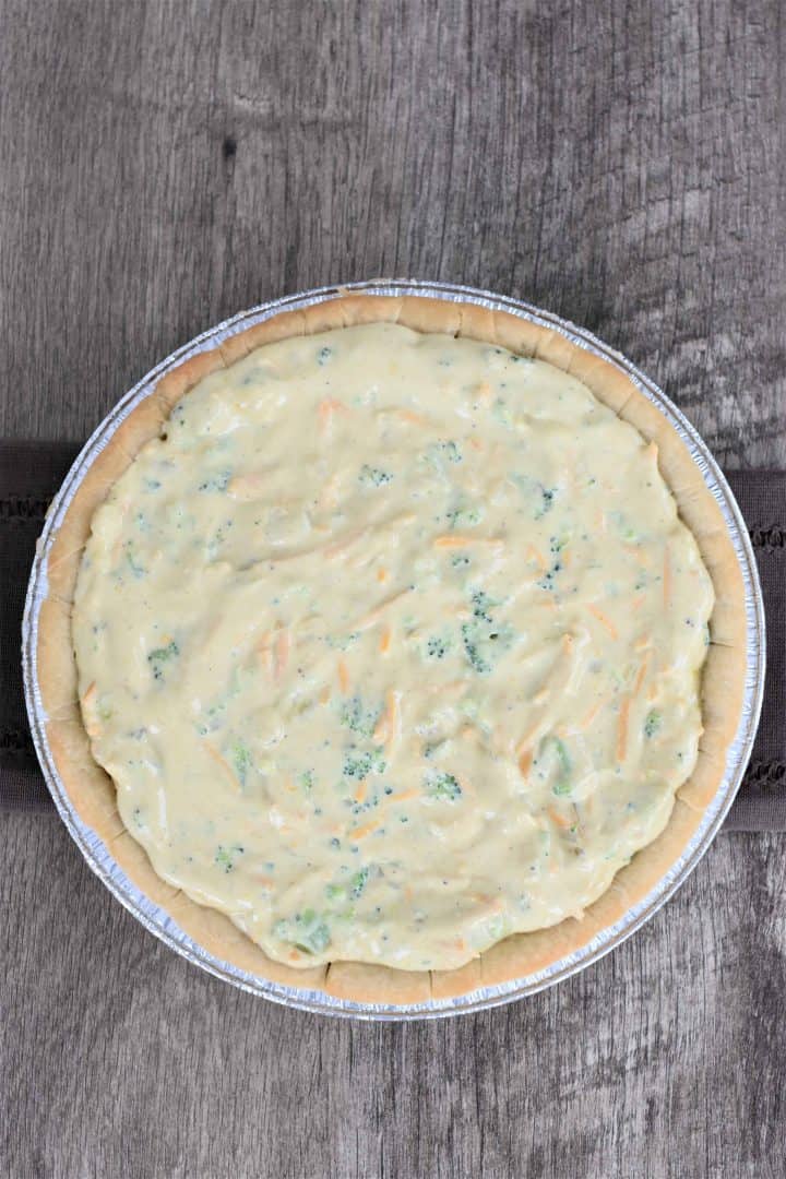 Quiche filling added to the par-baked pie shell