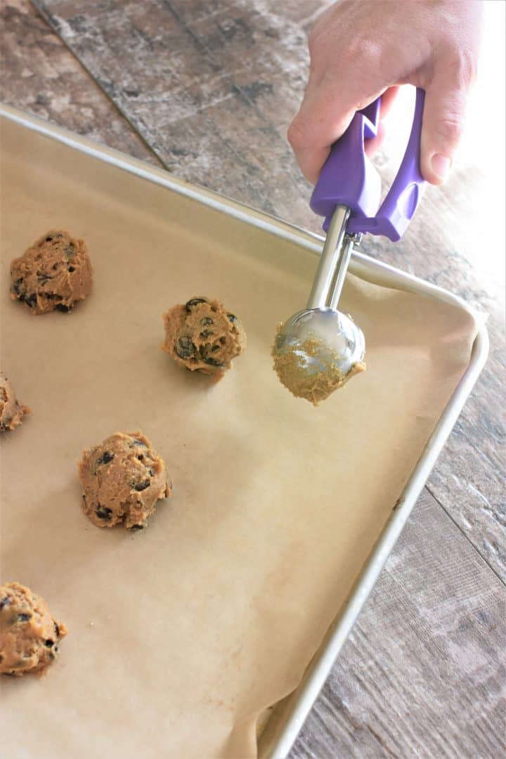Scooping cookie dough on a cookie sheet