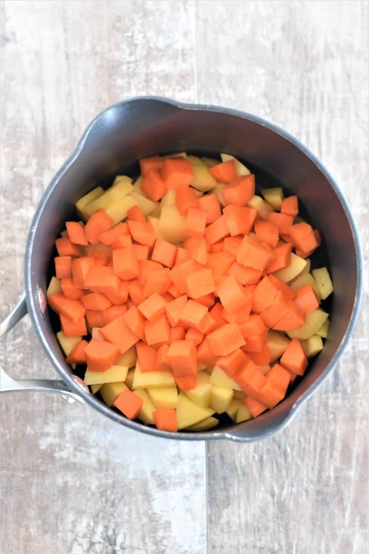 Chopped carrots and potatoes in a pot