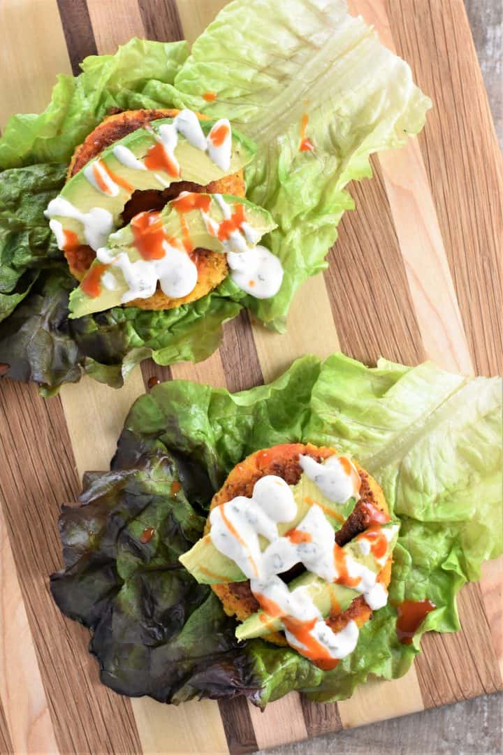 Chickpea Burgers on lettuce with avocado, Buffalo sauce and vegan ranch