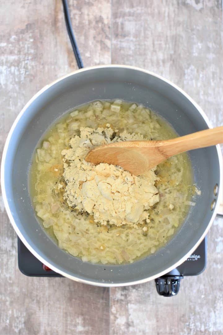 Chickpea flour being added to saucepan