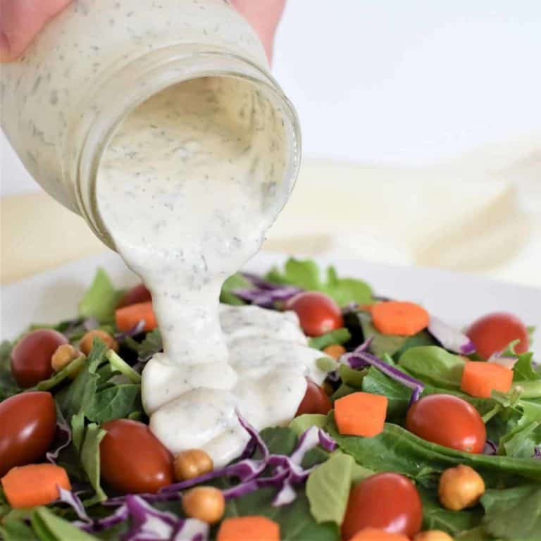 Pouring dressing on a salad
