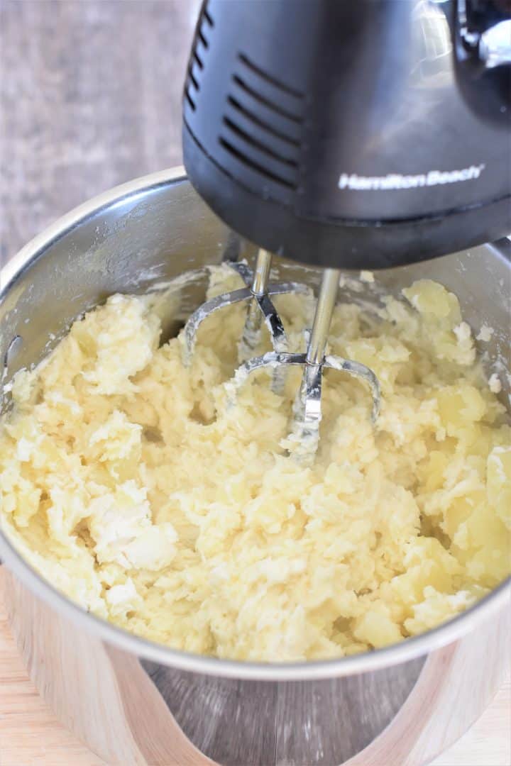 mixing potatoes with an electric hand mixer