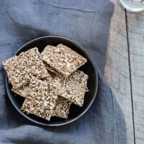 oat crackers in a bowl on a denim kitchen napkin