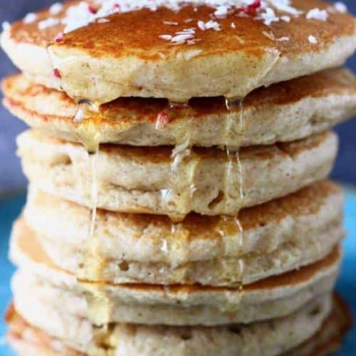 front view of stack of oat flour pancakes with syrup dripping from the top