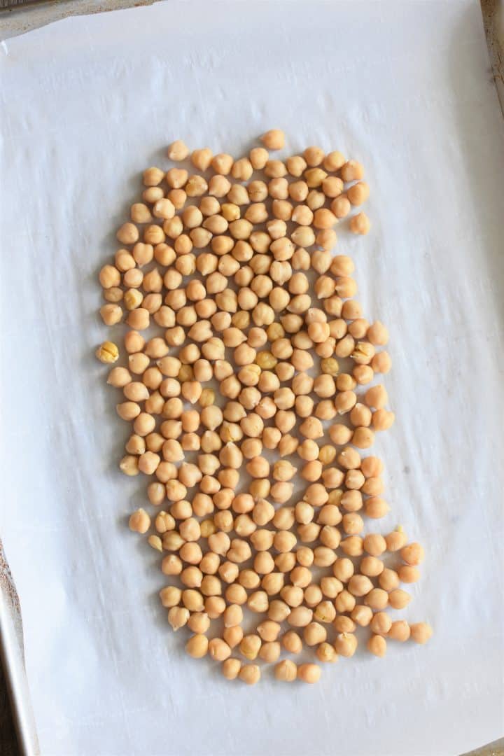 Chickpeas on a parchment-lined baking sheet