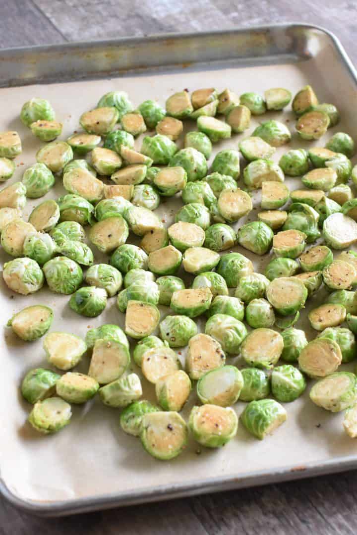 Brussels sprouts on baking sheet lined with parchment paper