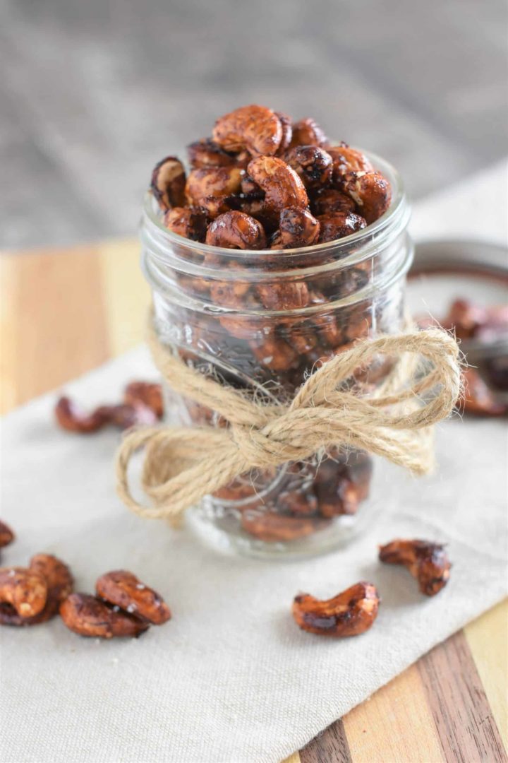 roasted cashews in a mason jar with a bow tied on it
