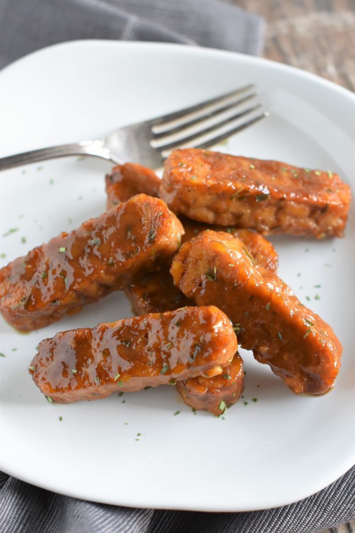 Maple Dijon Baked Tempeh on a white plate with fork at the back of the plate