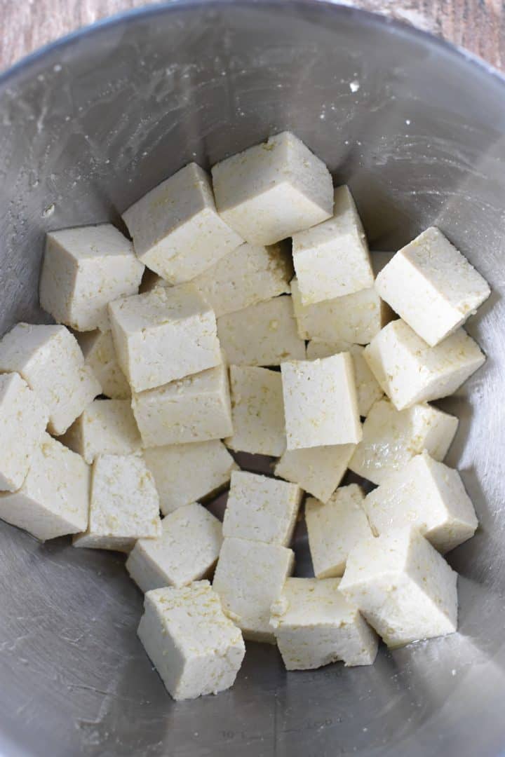 Tofu cubes in a mixing bowl