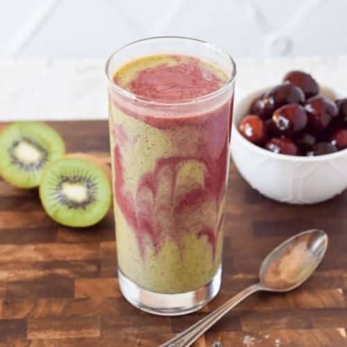 cherry kiwi smoothie in a tall glass.