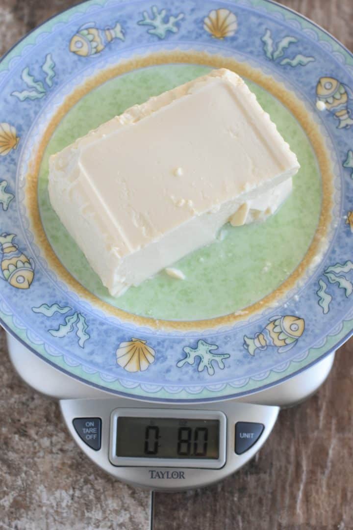 Weighing tofu on a kitchen scale