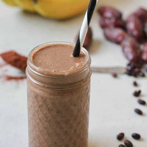 chocolate black bean brownie smoothie with a straw.