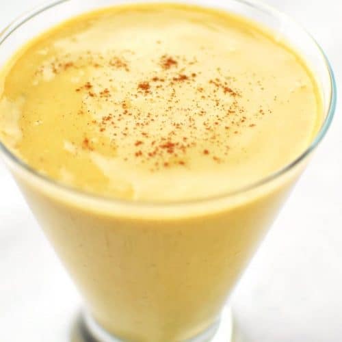close-up of turmeric smoothie in a glass.