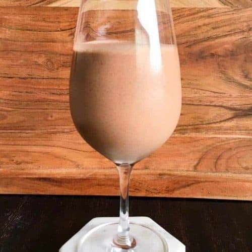 front view of vegan frosty in a wine glass.
