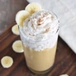 smoothie in a glass topped with non-dairy whipped cream