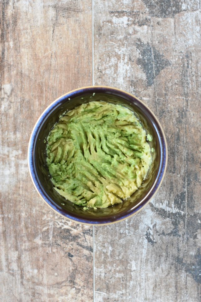 Mashed avocado in a small bowl