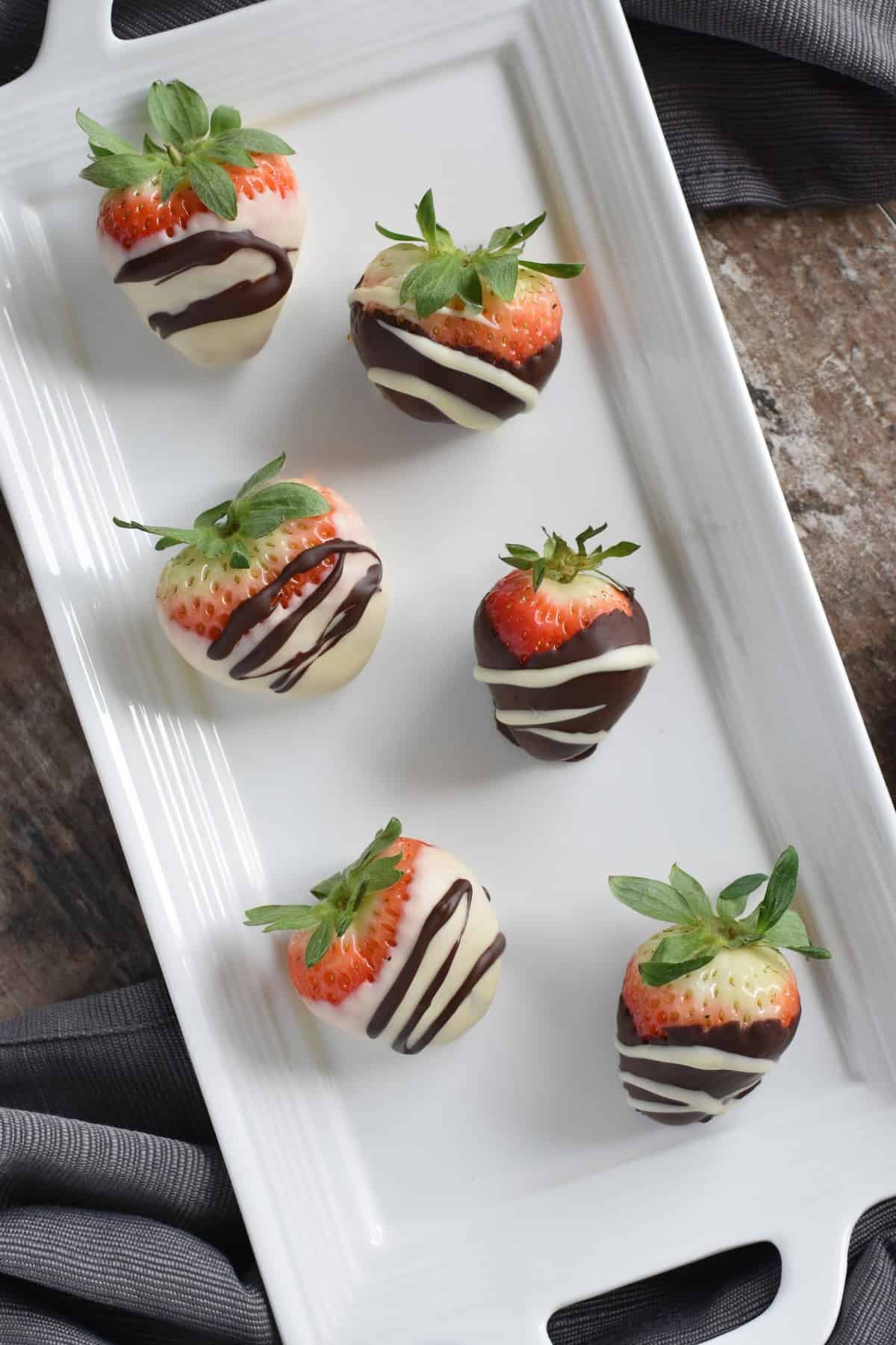 overhead of chocolate covered strawberries on white serving platter