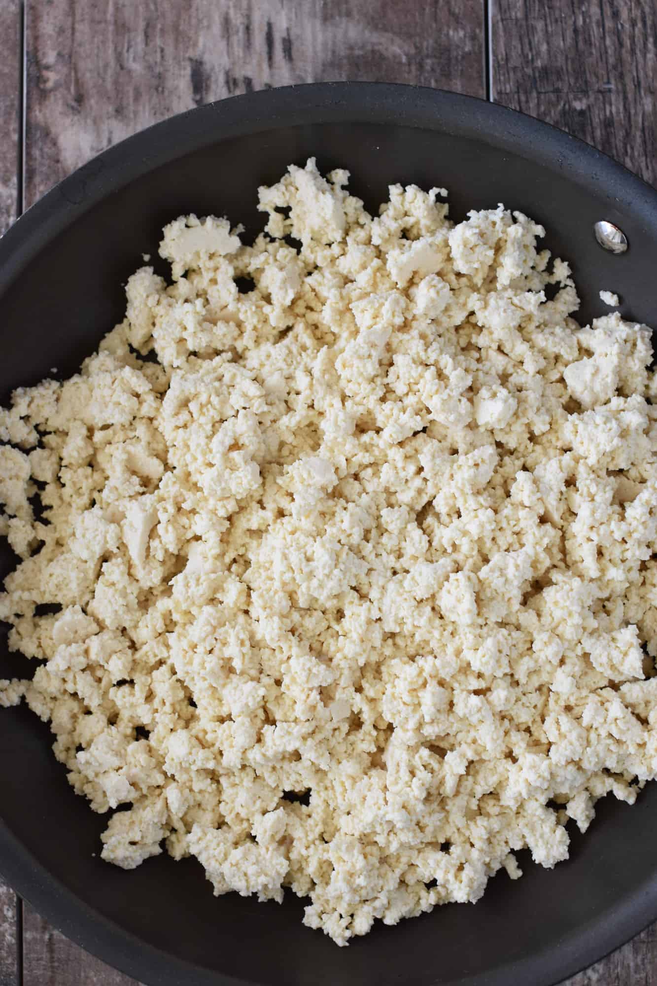 crumbled tofu added to nonstick skillet
