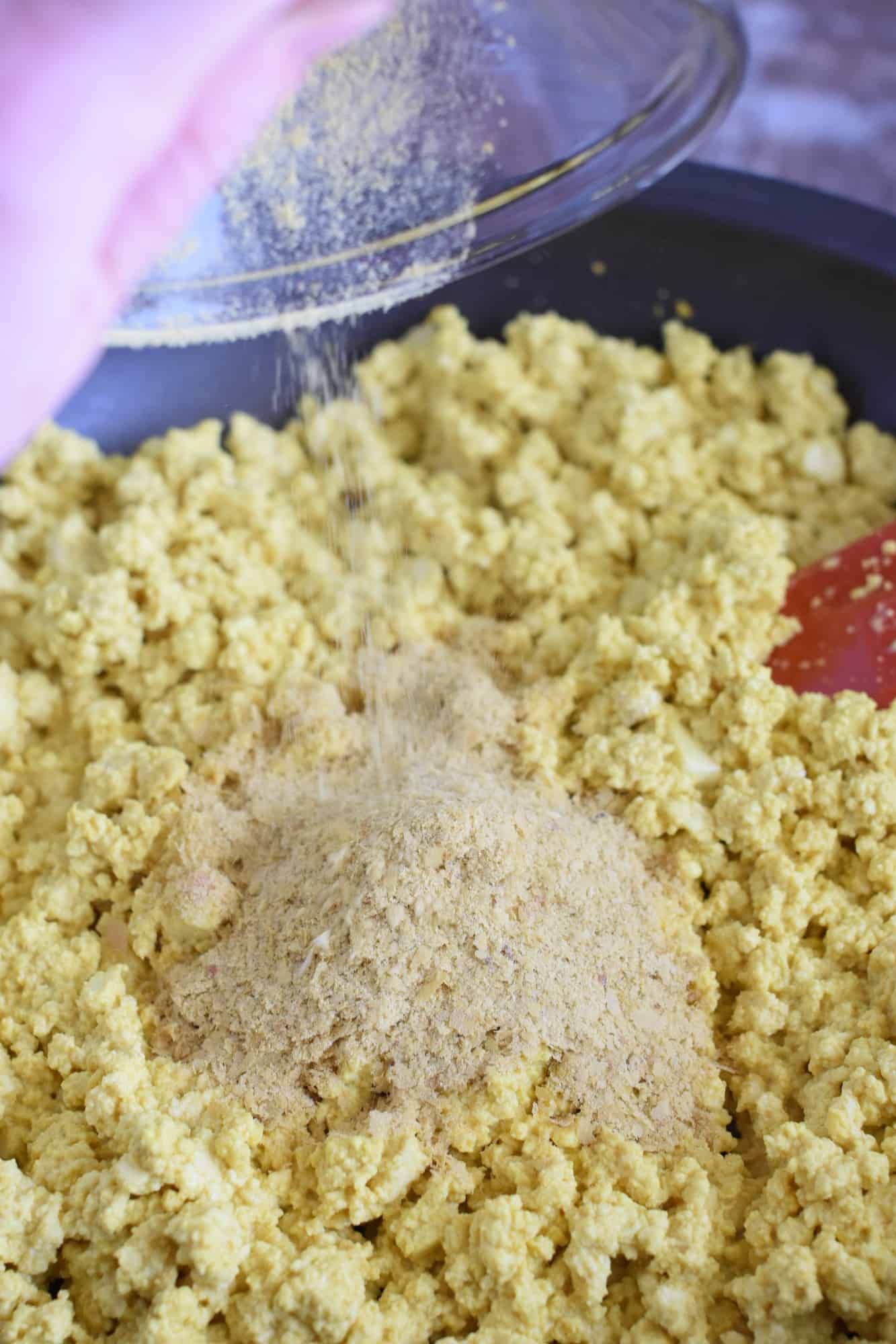 adding the nutritional yeast to the tofu