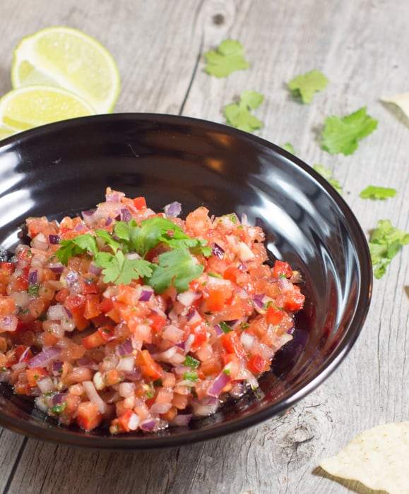 Homemade Salsa in a black bowl with cilantro on top