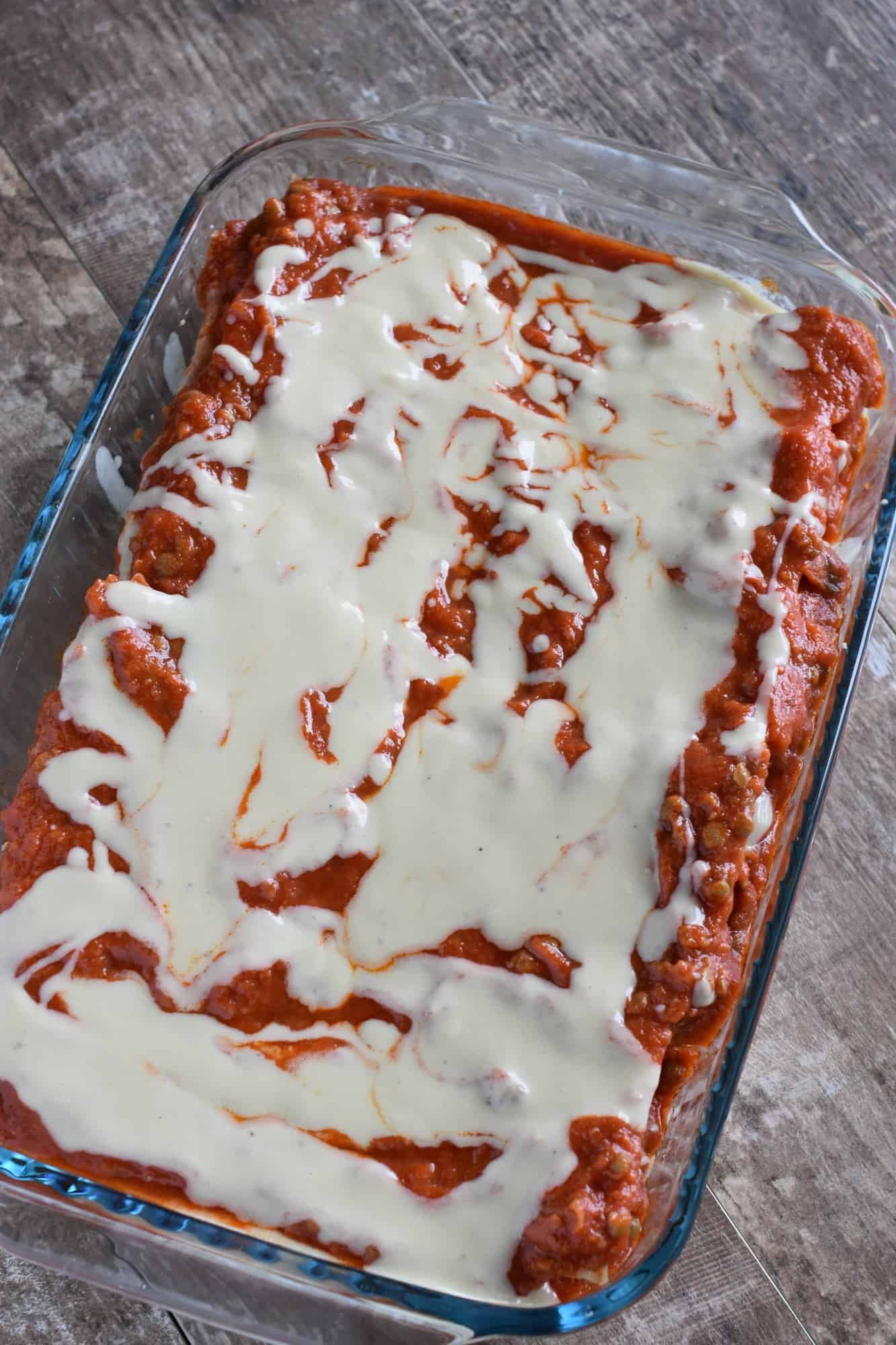 lasagna covered with remaining red and white sauce