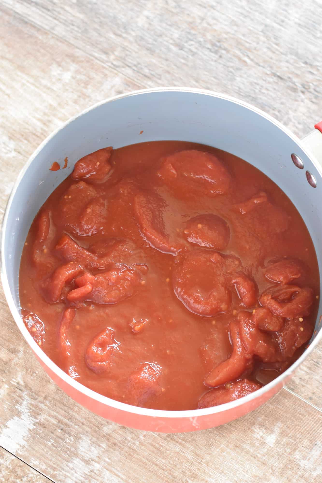 stewed tomatoes and tomato sauce added to pot