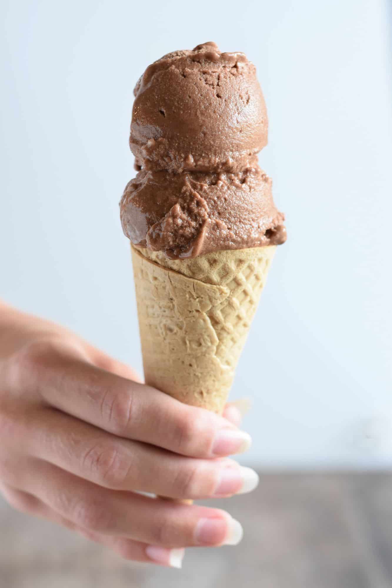 holding a cone with two scoops of nice cream