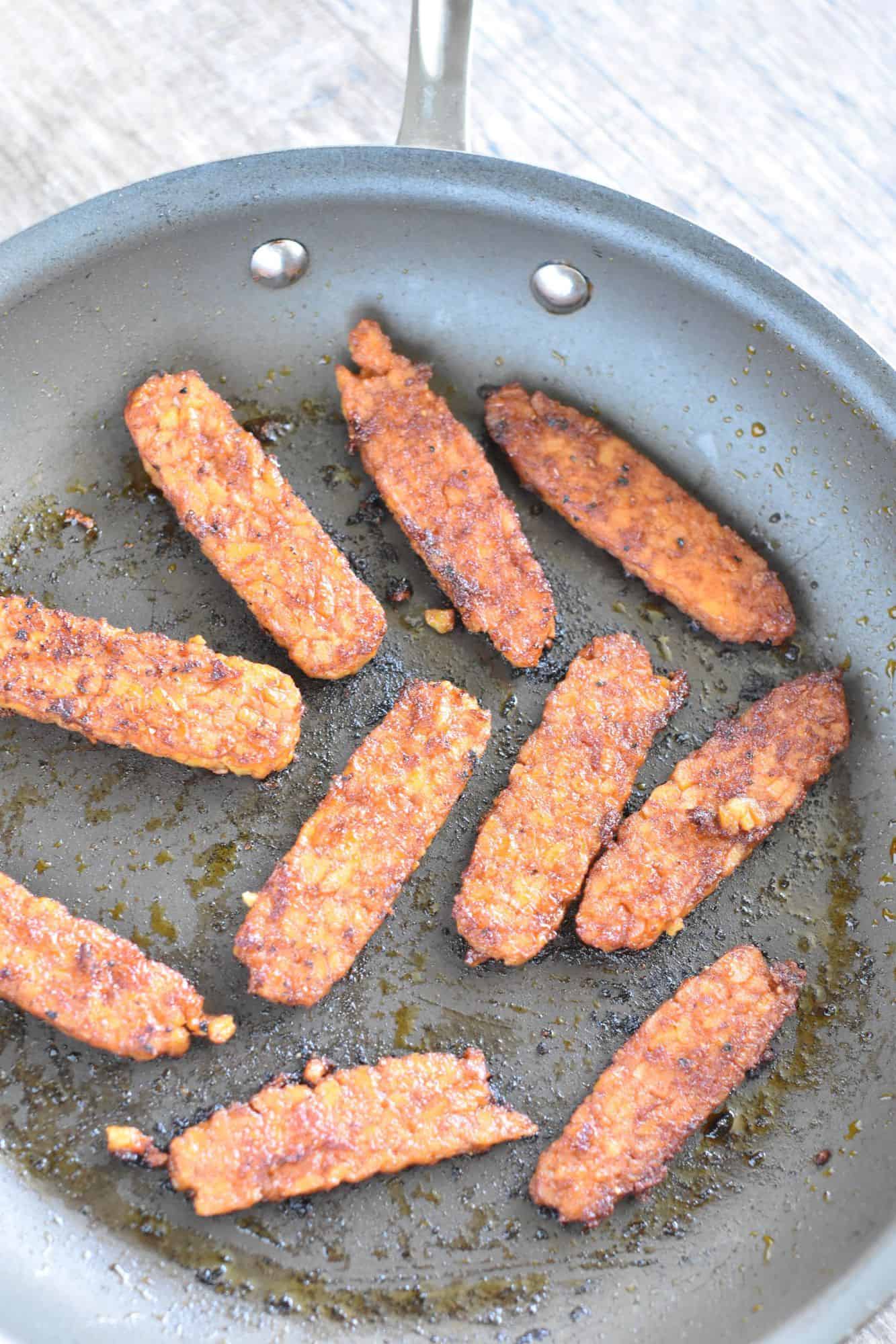 tempeh strips in nonstick pan after being cooked