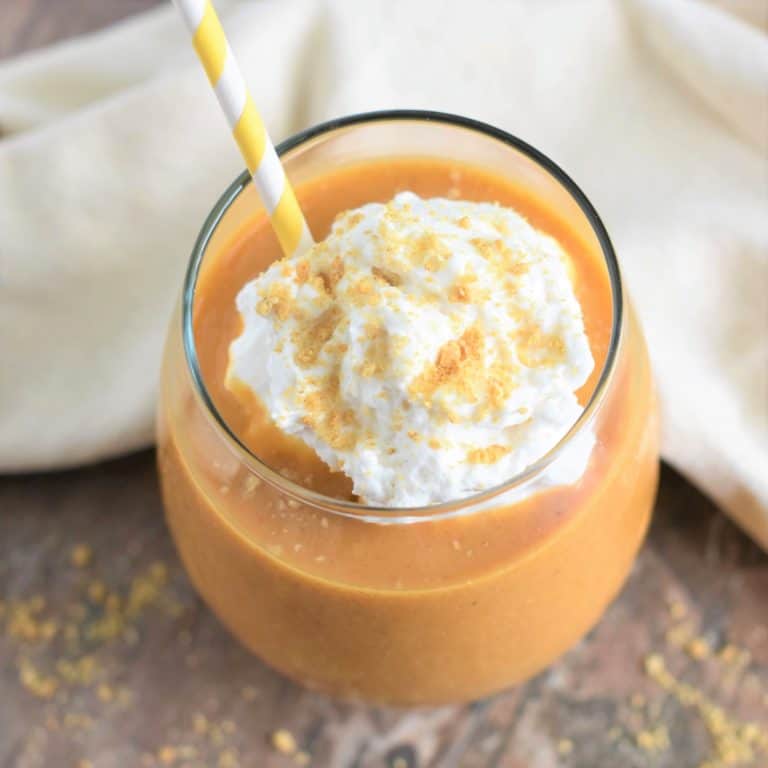 overhead of smoothie with non-dairy whip, crumbled grahams and a straw