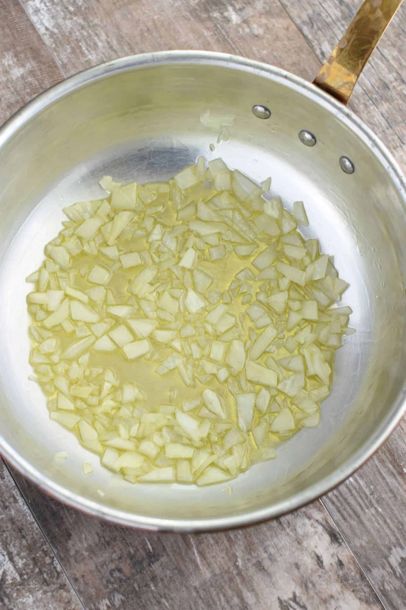 onion cooking in pan with olive oil