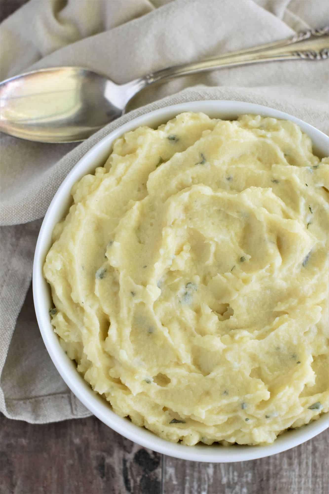 overhead of bowl of mashed potatoes with part of right side cut off