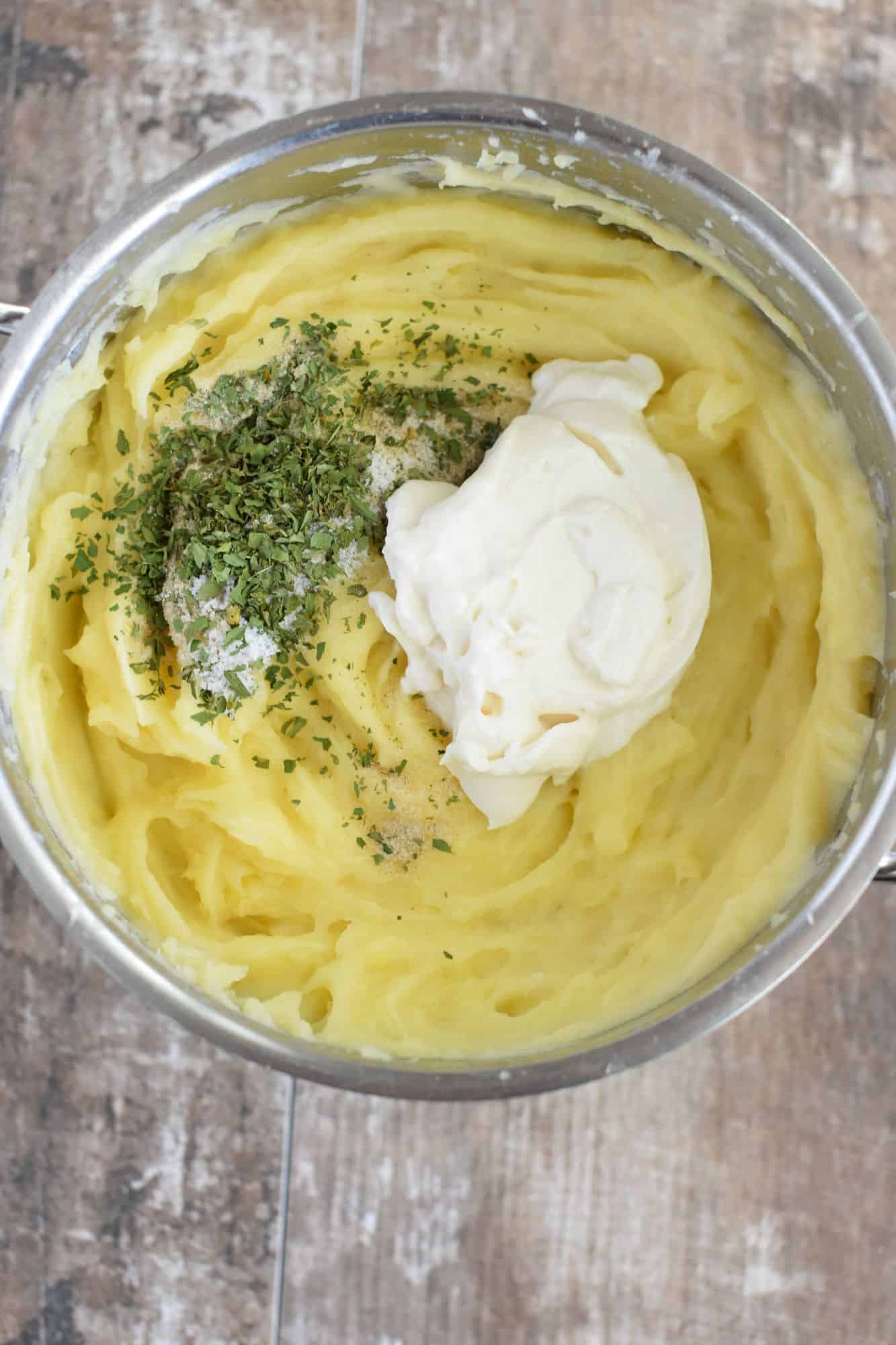 vegan mayo and seasonings added to potatoes in pot